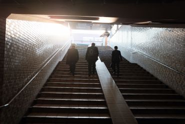 people-in-suit-going-up-the-stairs