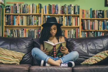 women-reading-book-surronded-by-books